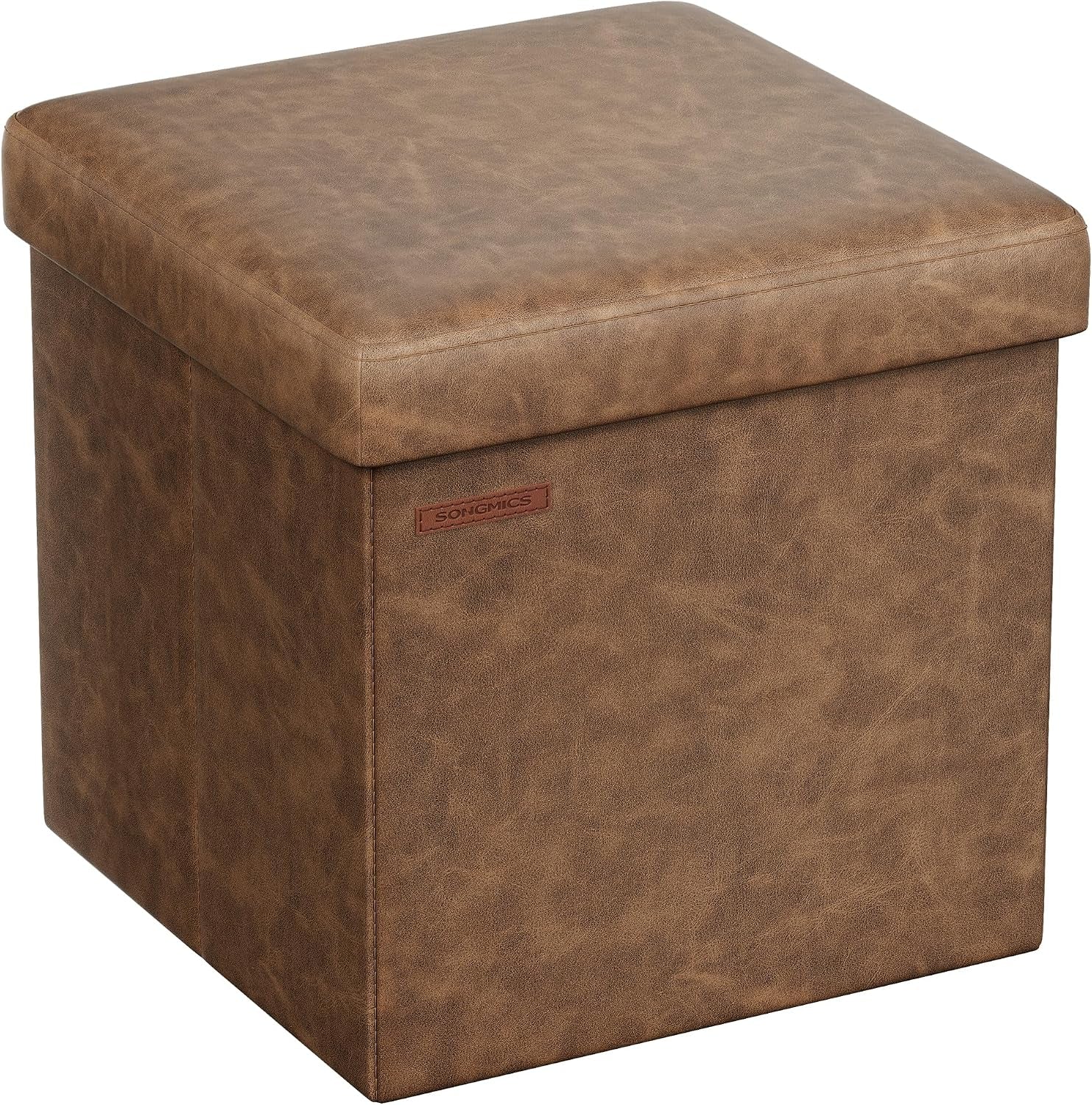 Square distressed brown faux-leather storage ottoman with cushioned lid, shown at an angle