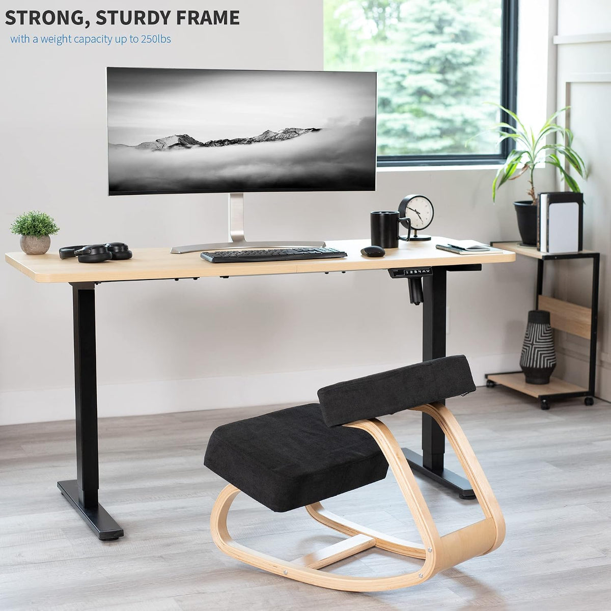 Kneeling ergonomic chair with black cushions and curved light-wood frame in a bright home office.