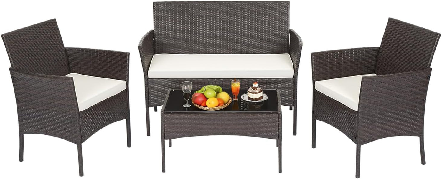 Dark brown woven loveseat and two matching armchairs with cream cushions and a rectangular glass-top table.