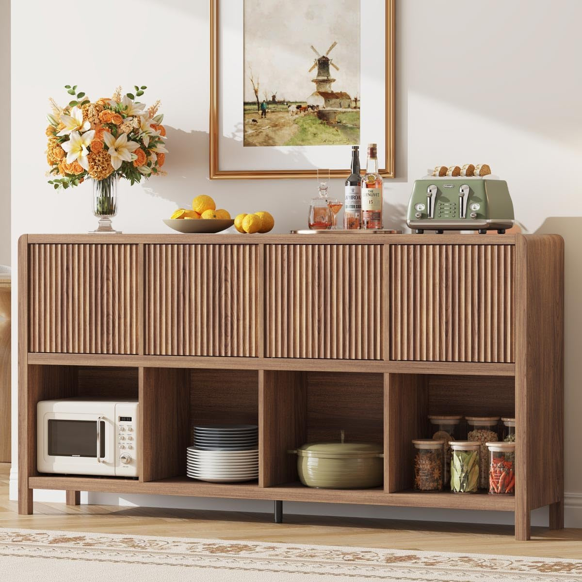 Walnut low horizontal bookcase with four ribbed doors and open cubbies, styled with vase, fruit bowl and toaster