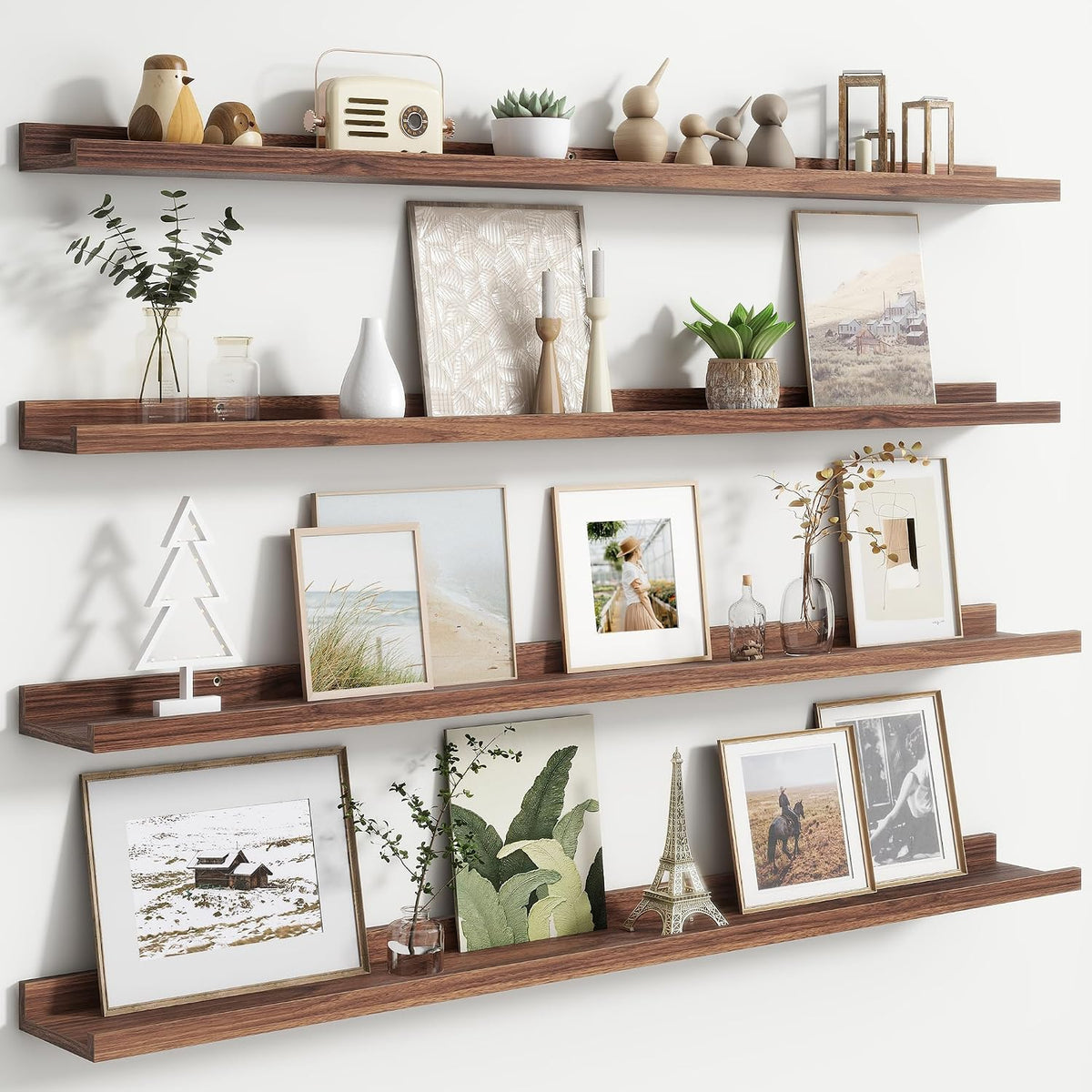 Walnut floating picture ledges styled with framed photos and decorative objects, straight-on view