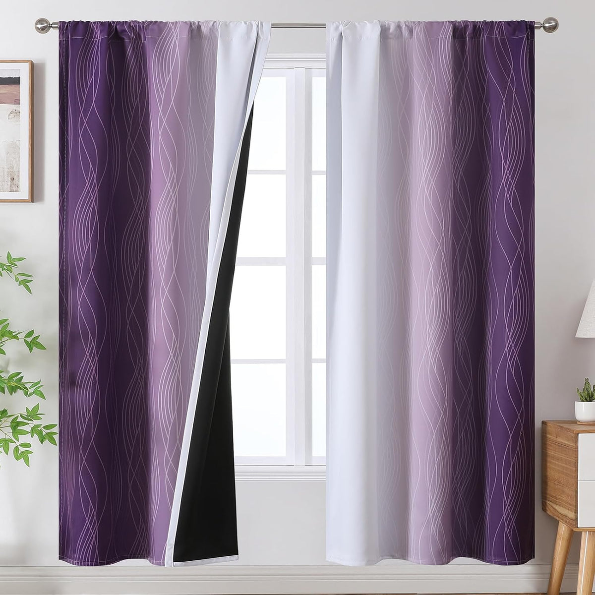 Window dressed with purple-to-white gradient curtains, one panel folded back to show black lining.