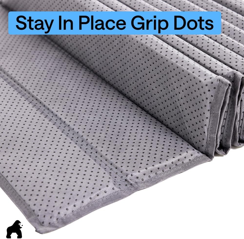 Close-up of grey support fabric with many small black grip dots and label text