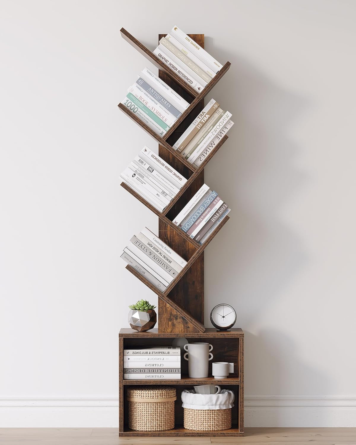 Front view of a tall tree-style wooden bookshelf with six zigzag shelves and a two-cubby base holding baskets and decor.