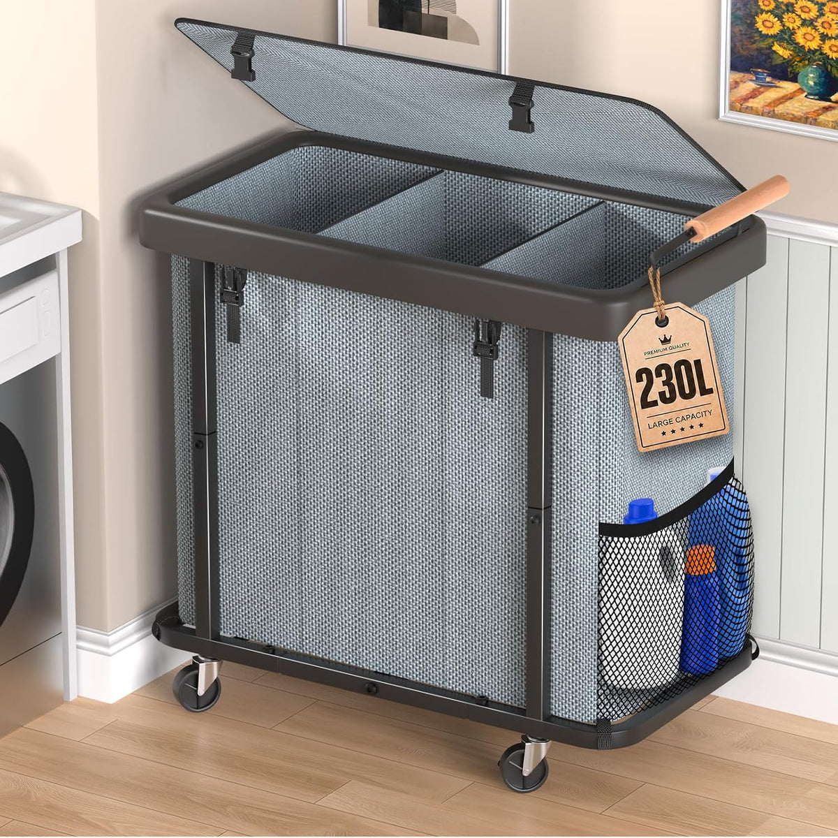 Angled front view of a gray woven three-compartment laundry sorter with lid open, wooden handle and mesh side pocket