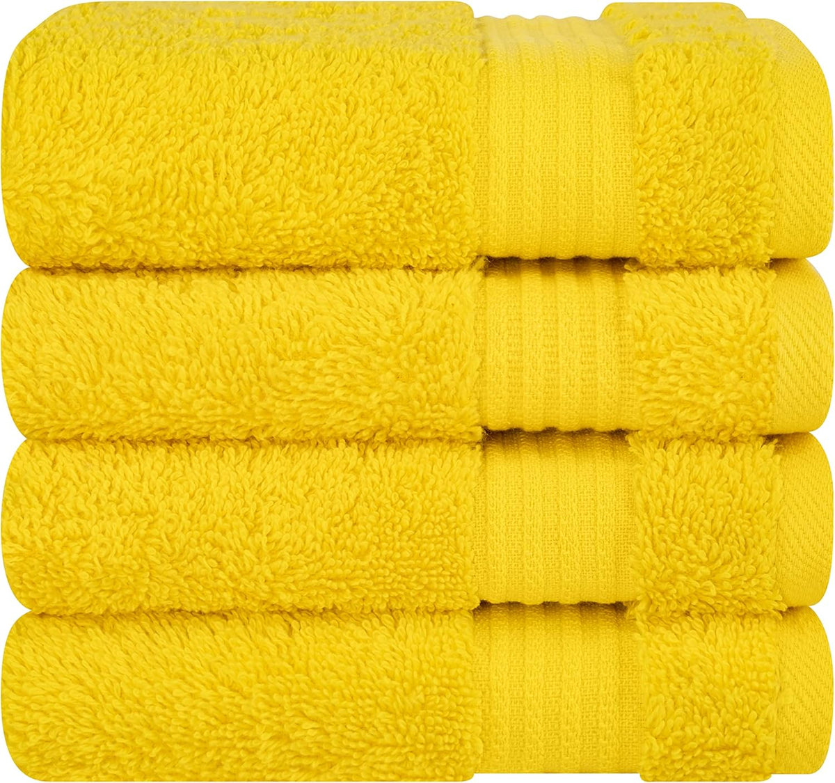 Close-up of a stack of four bright yellow terry towels highlighting plush loops and banded trim.
