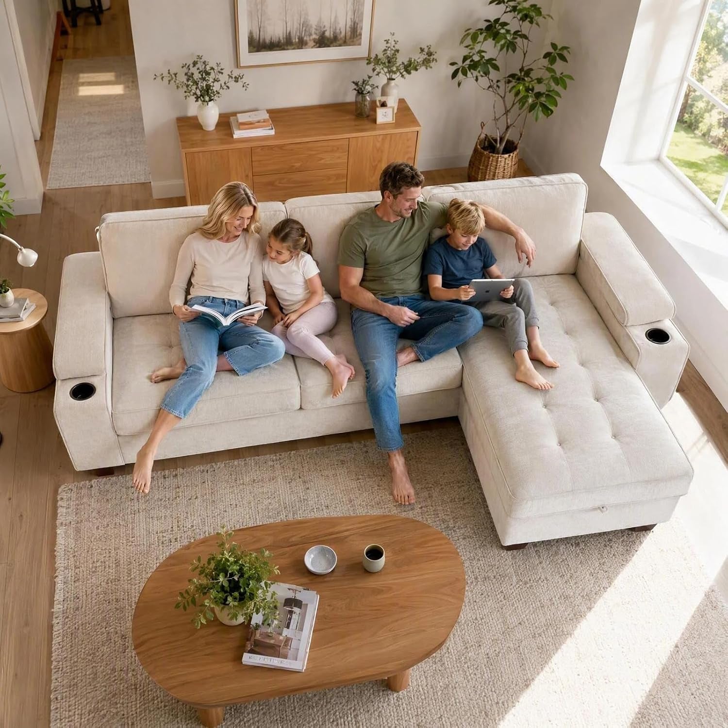 Overhead shot of a beige L-shaped couch with a family sitting across the seats and a tufted chaise on the right.