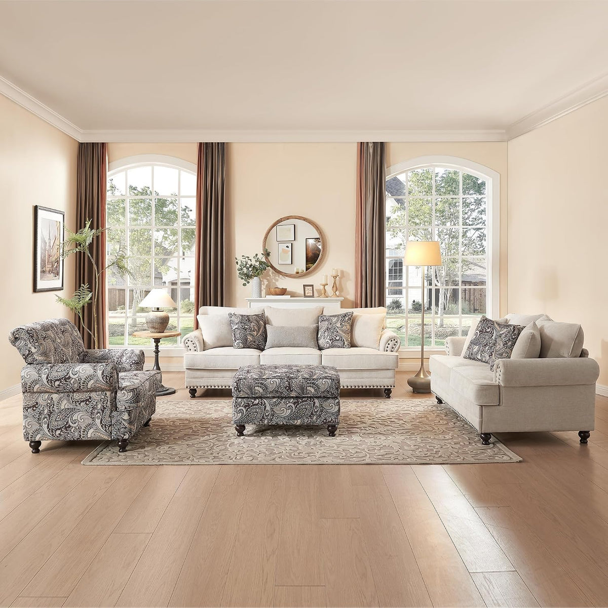 Full living room scene with matching sofa, loveseat, patterned armchair and ottoman on a rug.