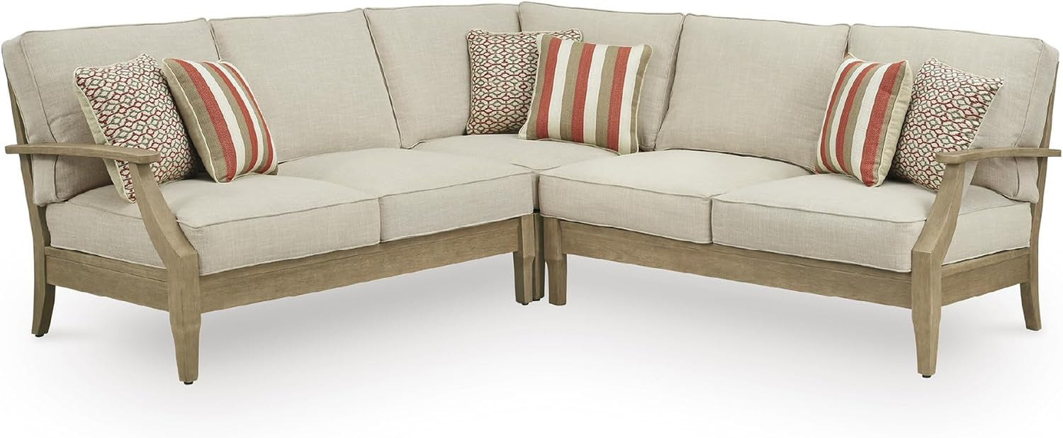 Corner-view of the beige cushioned sectional on eucalyptus frame with striped and patterned pillows