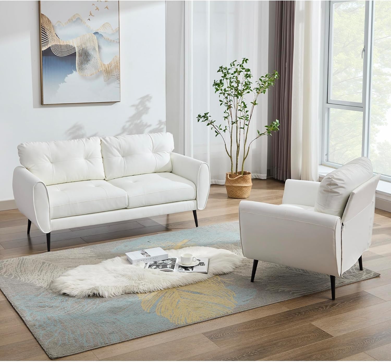 White loveseat and single chair facing each other in a sunlit room with potted plant, rug, and wall art.