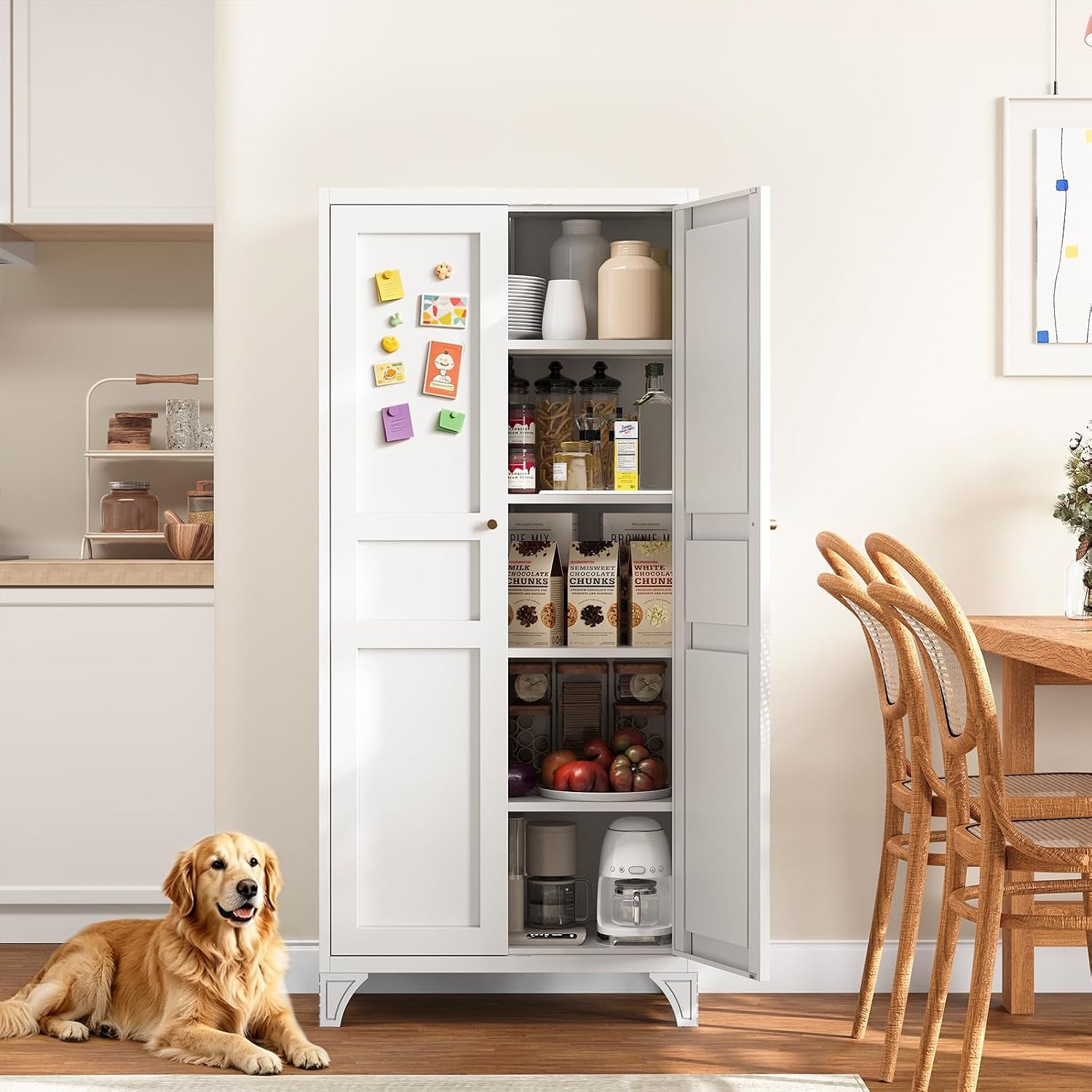 White pantry cabinet with right door open showing stacked pantry goods, appliances and magnets on the left door