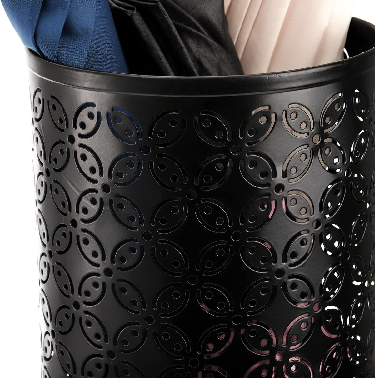 Close-up of black metal perforated floral pattern on the umbrella stand