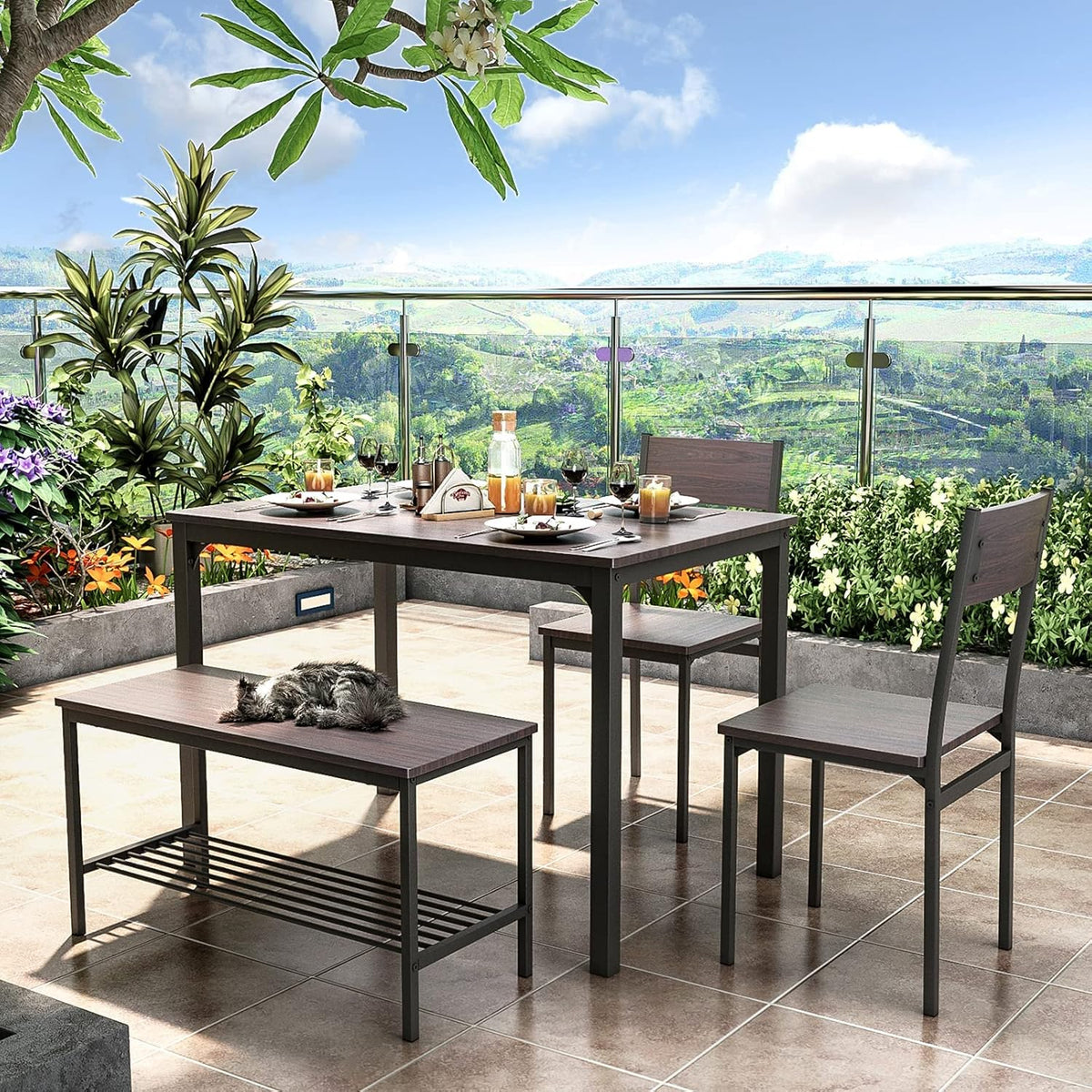 Dining set staged on a sunny balcony with scenic valley view, table set for four and a cat napping on the bench