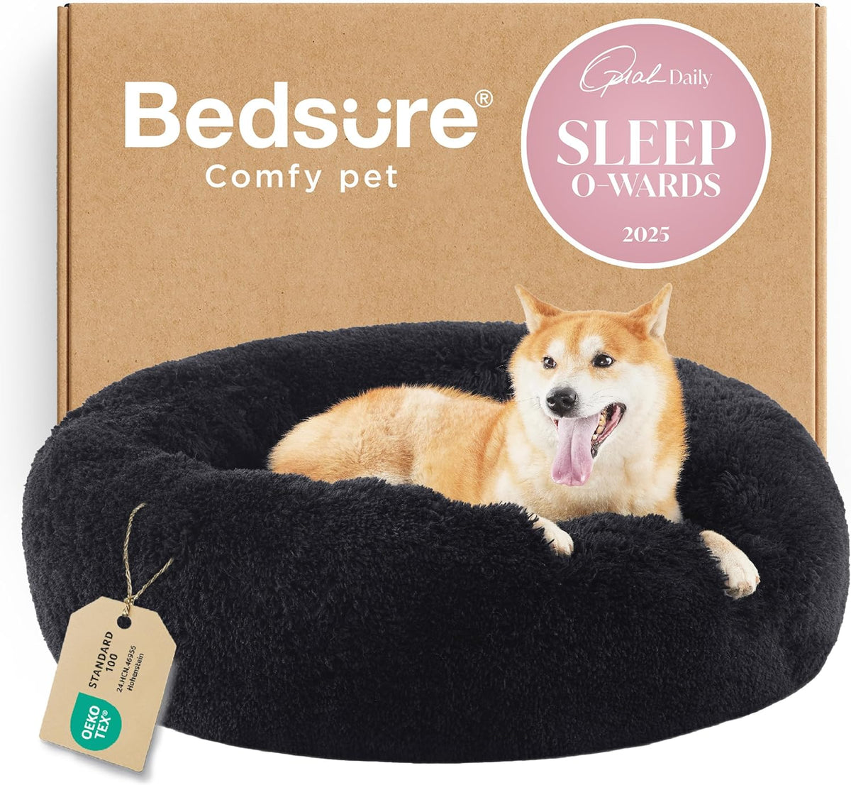 Black round faux-fur donut bed with a dog lounging in front of a cardboard box