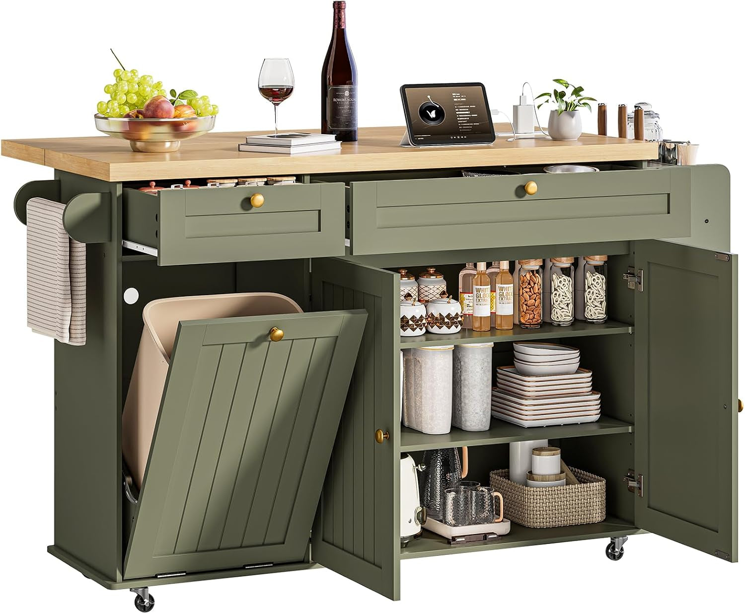 Olive green kitchen island with wood top, open doors and drawers displaying pantry jars, dishes and a tilted bin.