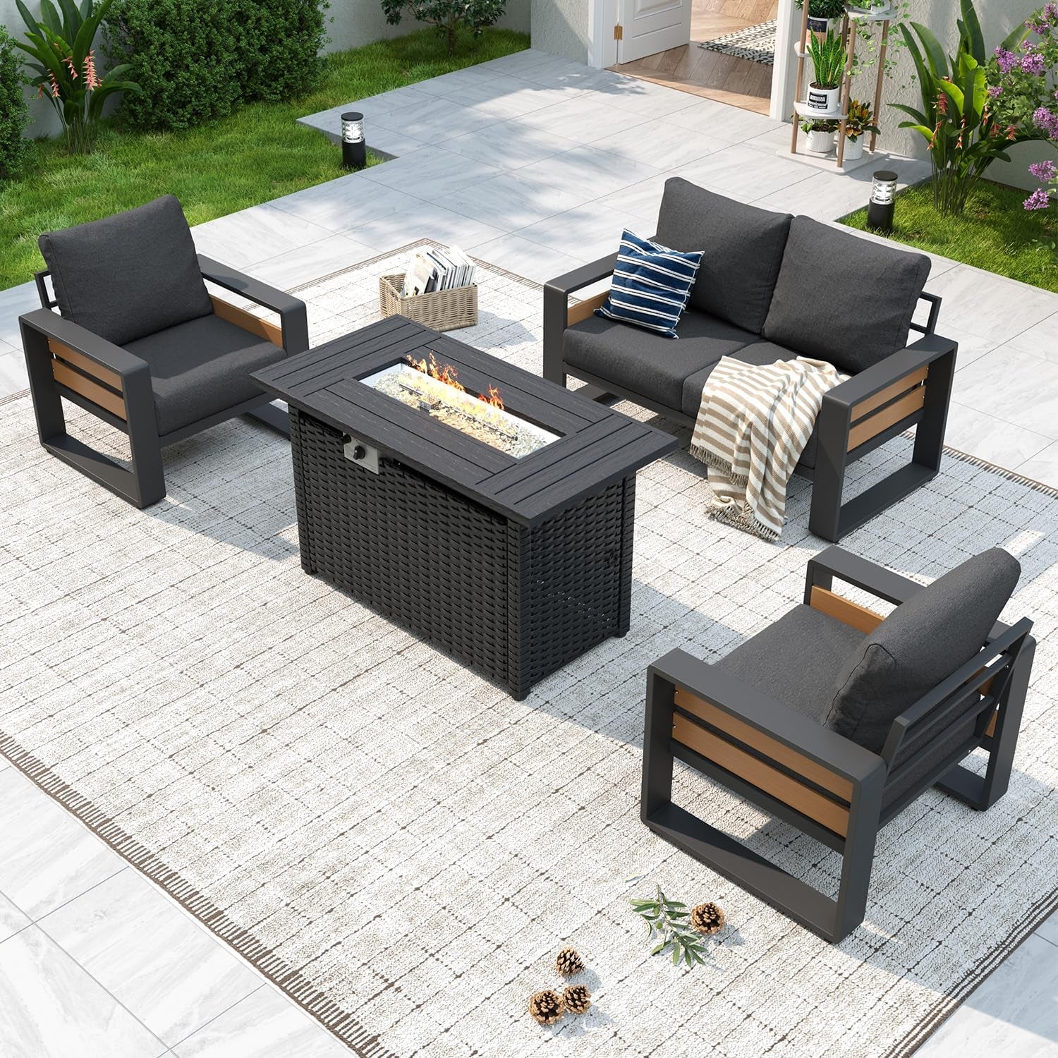 Wide overhead shot of the full outdoor seating arrangement with chairs, loveseat and a lit rectangular fire-pit table.