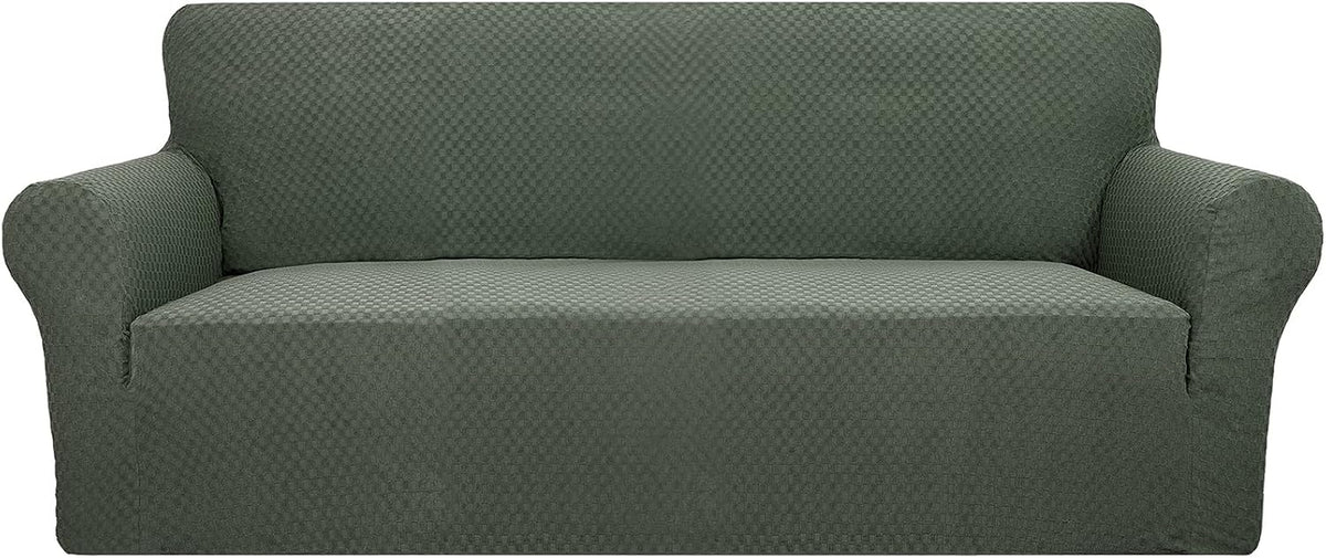 Straight-on shot of a three-seat sofa covered in a deep green textured stretch slipcover on a plain white background.