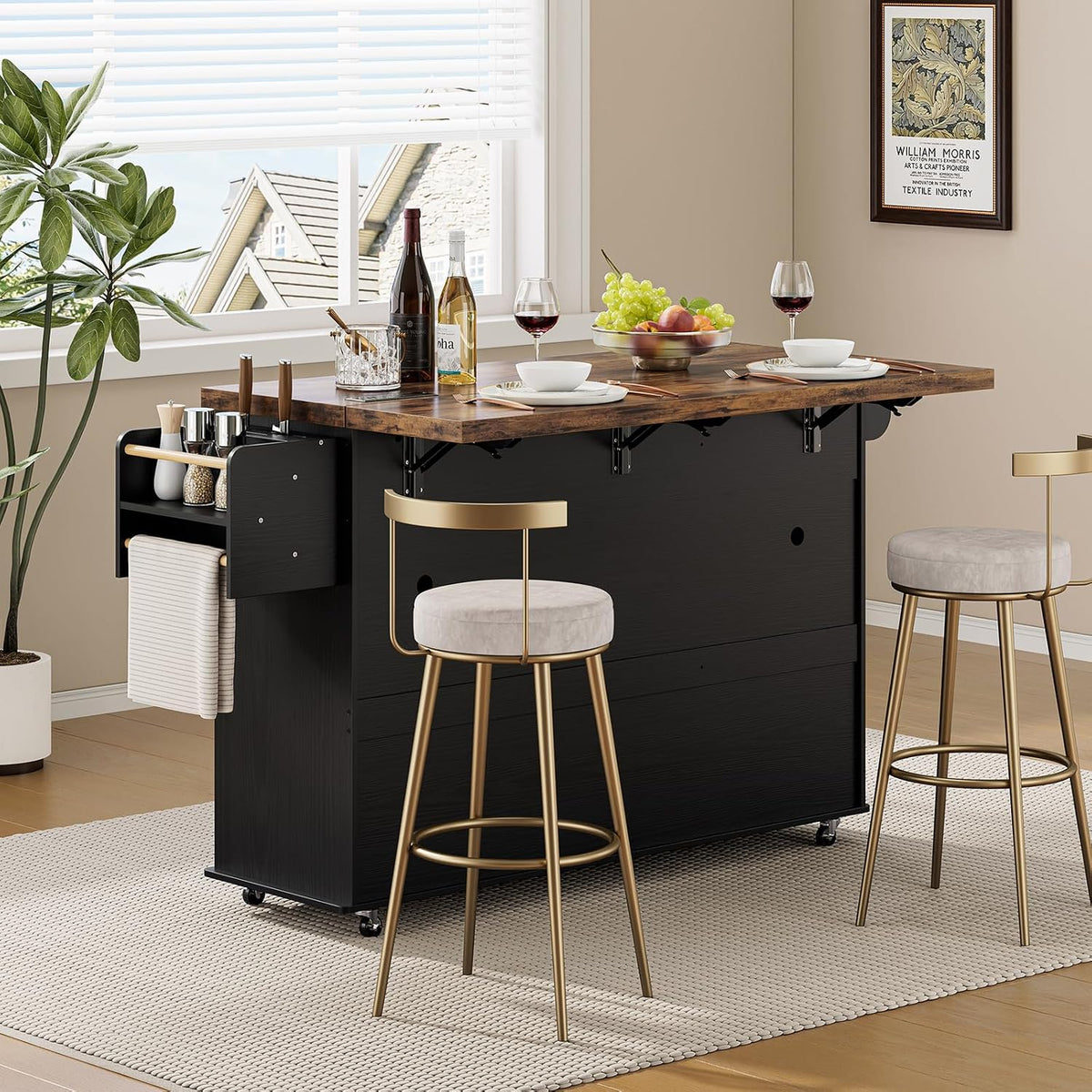 Back view of the island used as a bar with folded drop leaves, two gold-frame bar stools and tabletop place settings.