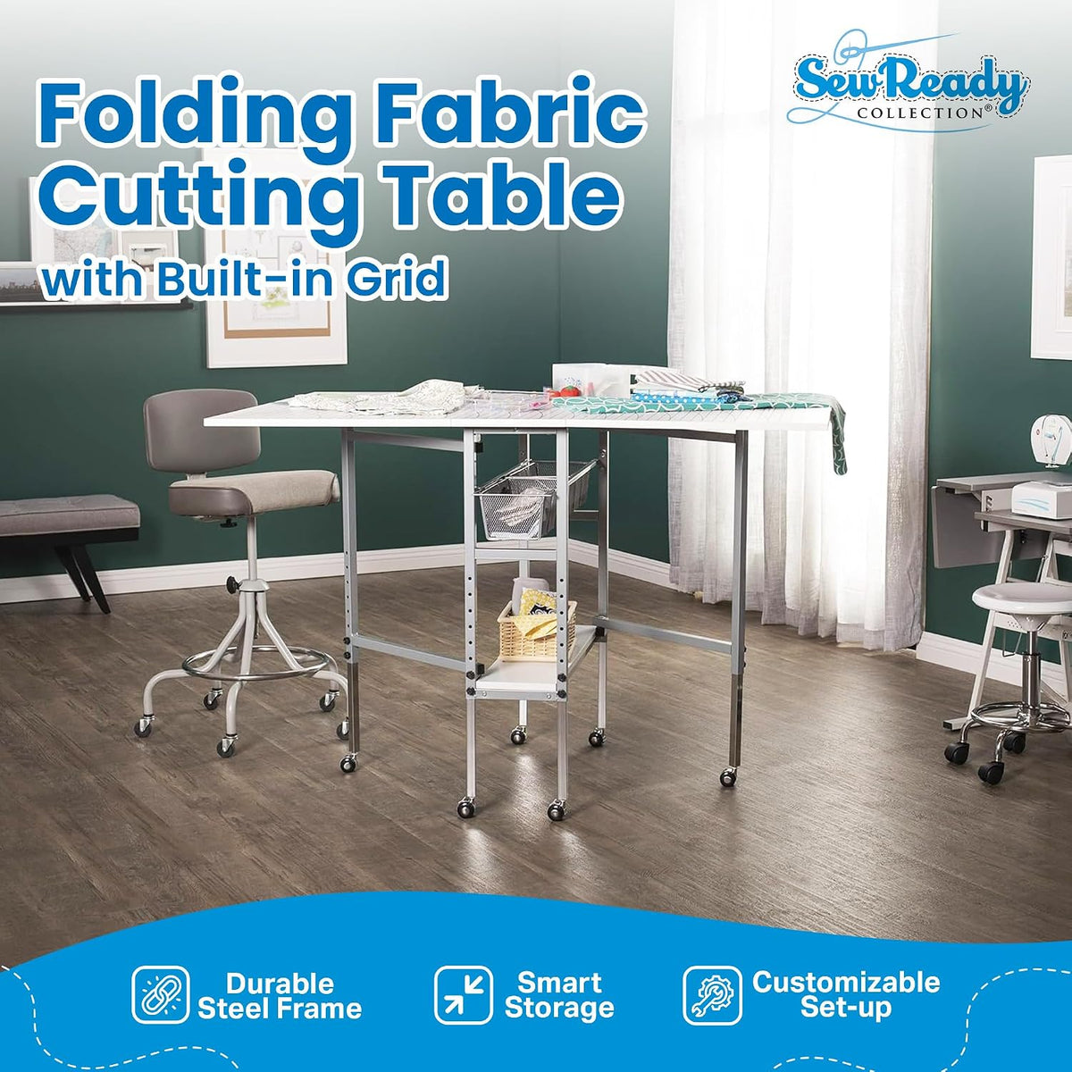 Craft table set up in a bright room with rolling stool, fabric on the grid top and wire storage baskets underneath