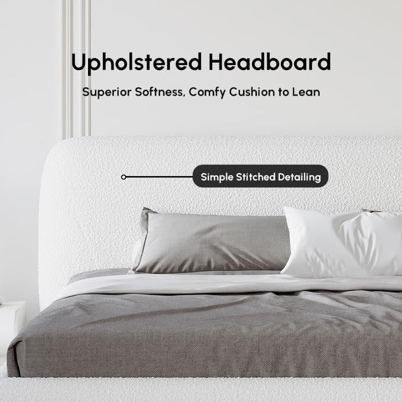 Close-up of rounded white boucle upholstered headboard showing simple stitched detailing