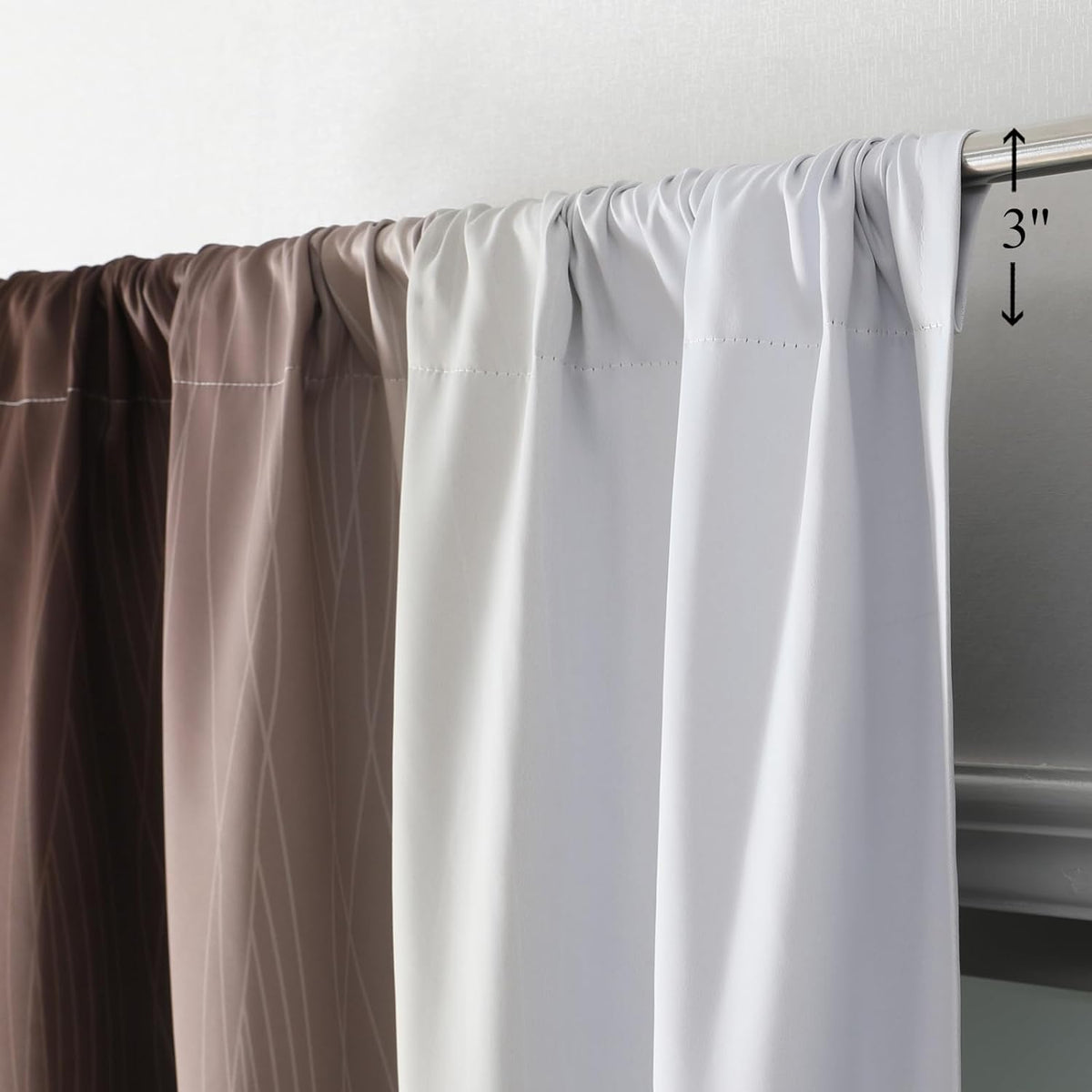 Top view of four ombre curtain panels gathered on a metal rod showing the rod-pocket header