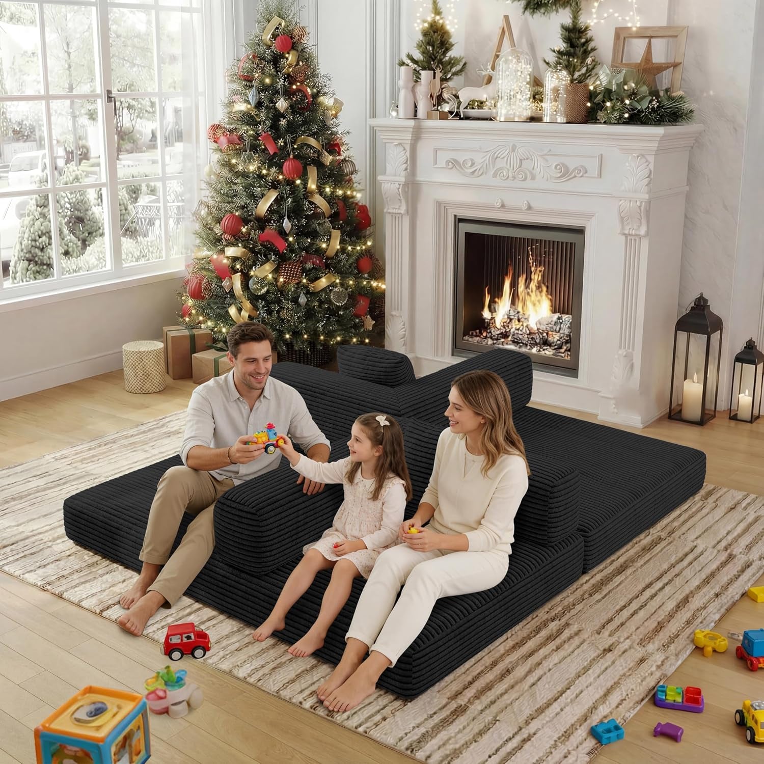 Parents and child sitting on the sofa bed arranged with lowered backrests to form a wide lounge area.