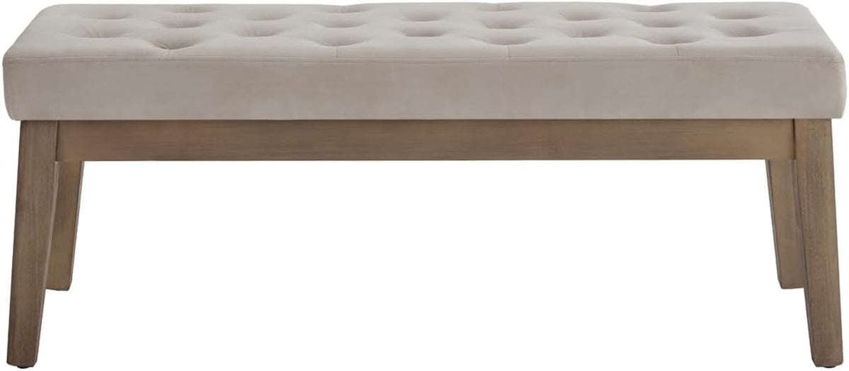 Front-facing view of a tufted padded bench with visible solid wood base and angled wooden legs on a white background