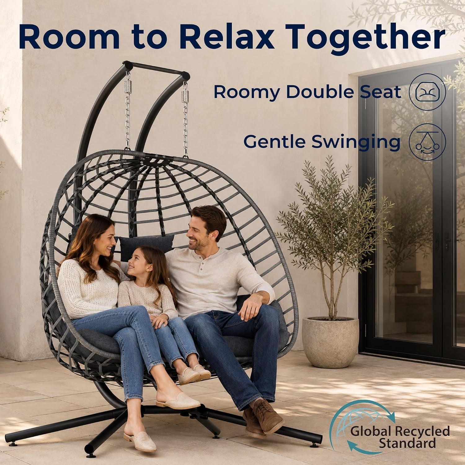 Dark gray double egg swing with freestanding stand shown with family seated on a patio, lifestyle view