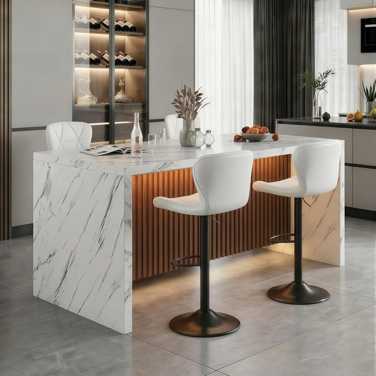 Angled view of white faux-marble island table with brown fluted front and white bar stools.