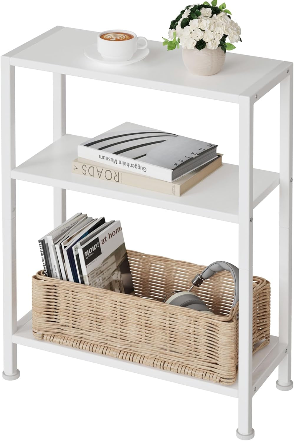 White three-tier narrow side table with metal frame; top holds a coffee cup and potted white flowers, middle has stacked
