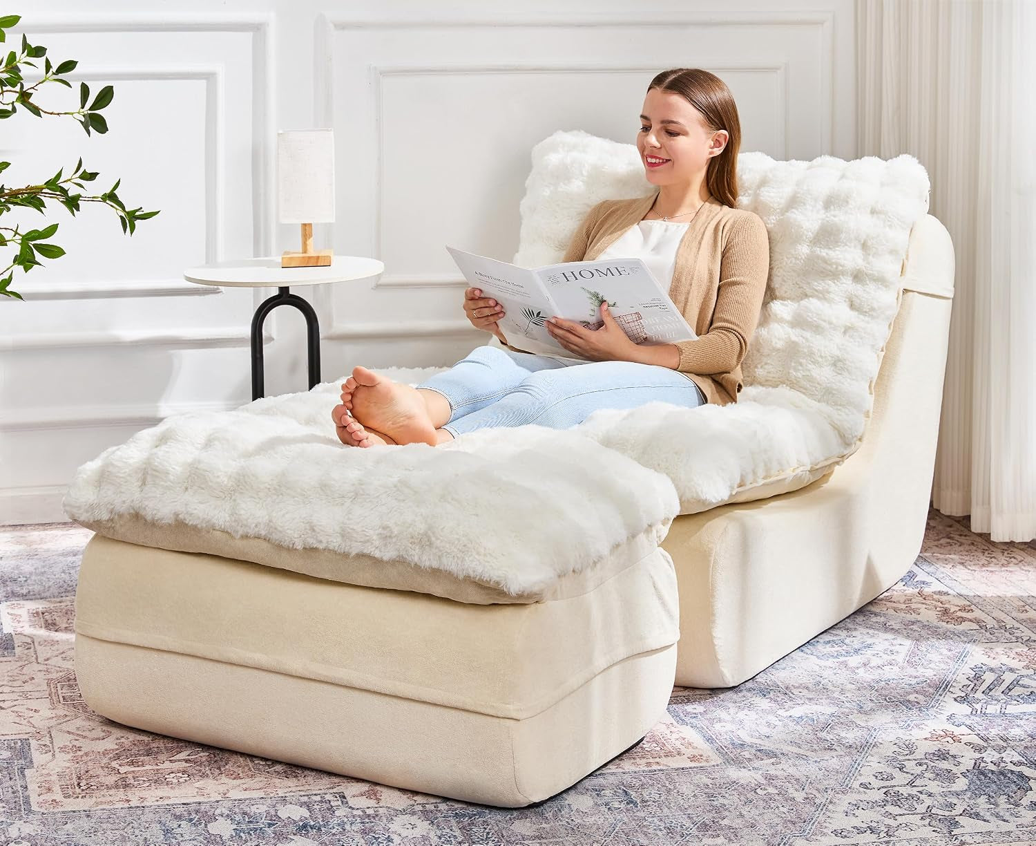Cream memory‑foam chaise with separate ottoman and fluffy removable cover; woman reclining and reading.