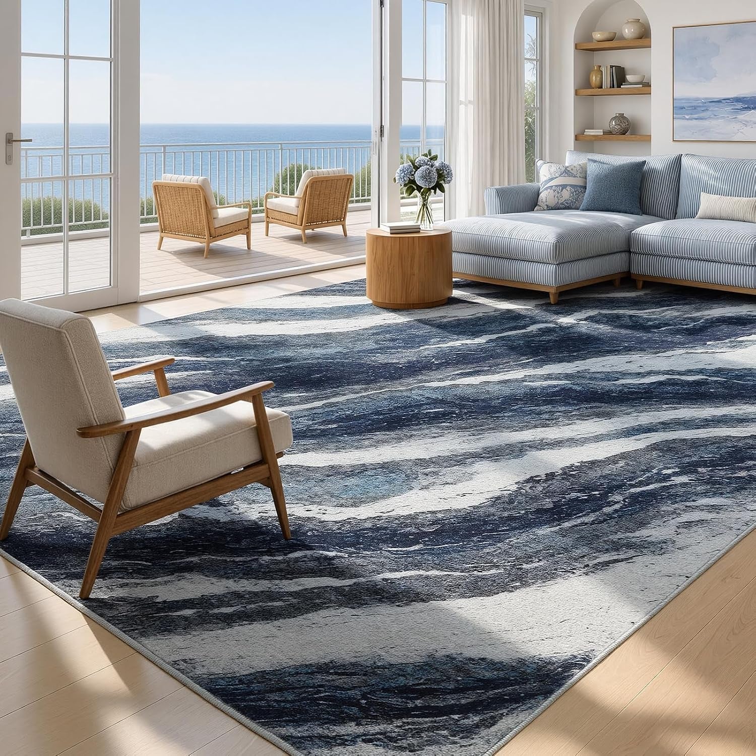 Blue and white abstract ocean-wave area rug laid in a sunlit living room angled front view
