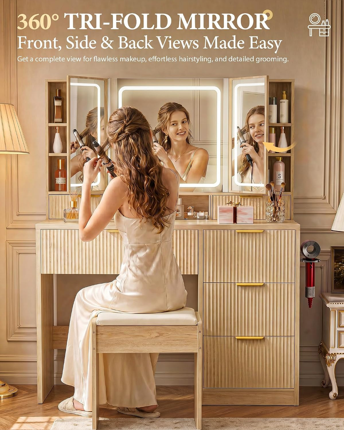Vanity desk with open tri-fold mirror and side cabinets, model styling hair at the seat
