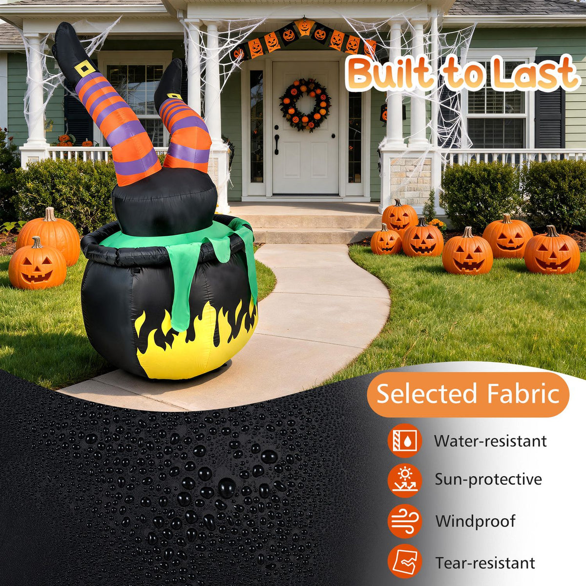 Inflatable witch legs rise from a flaming cauldron beside a home, with a close-up of water beading on fabric.