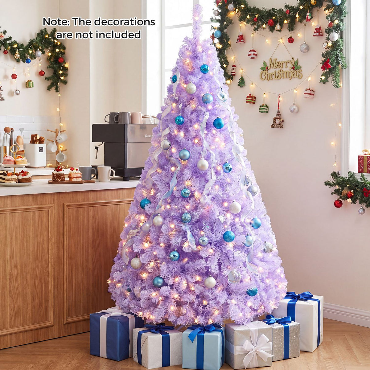 A lit lavender Christmas tree with blue and white ornaments stands beside a kitchen counter.