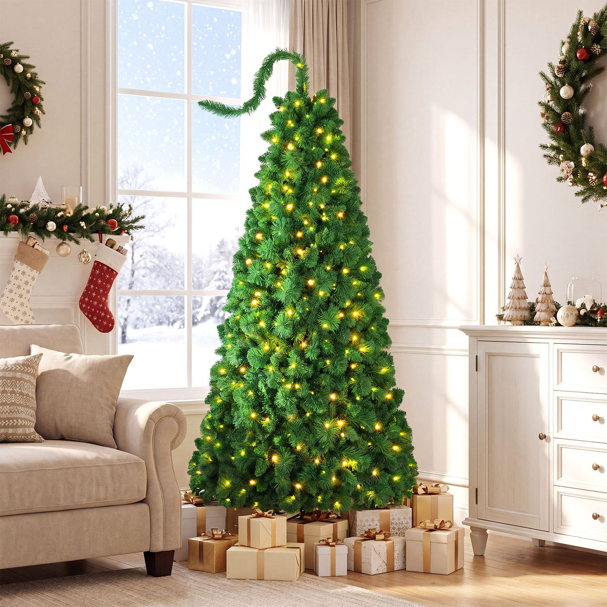 Lit green Christmas tree with a curled top stands among wrapped gifts in a bright living room.