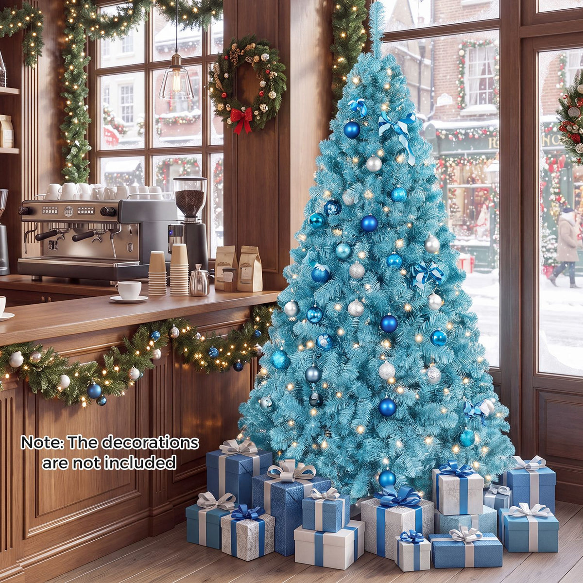 A glowing blue Christmas tree decorated with blue and silver ornaments beside a café counter.