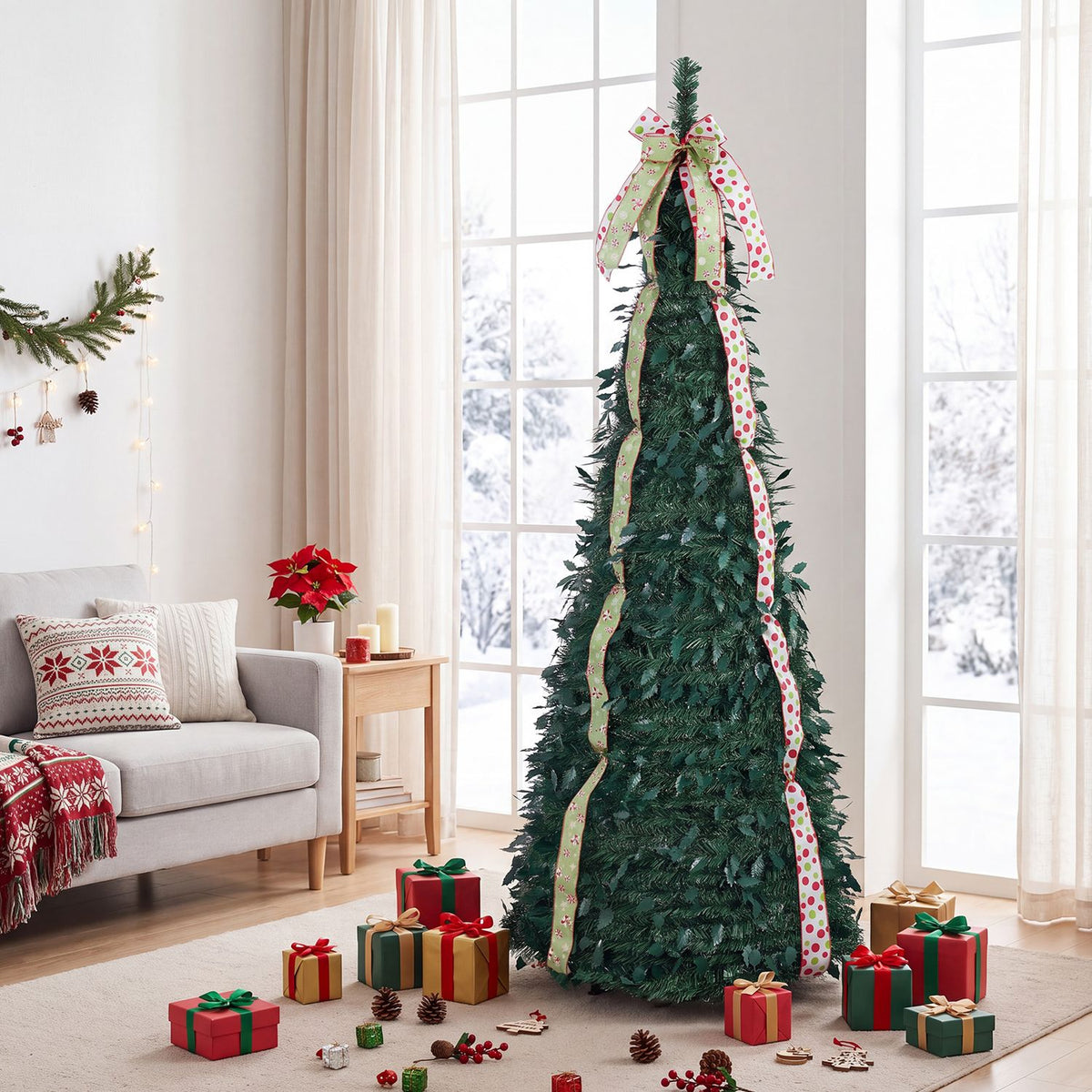 Decorated green Christmas tree with long patterned ribbons and a large bow, displayed beside a sofa and wrapped gifts.