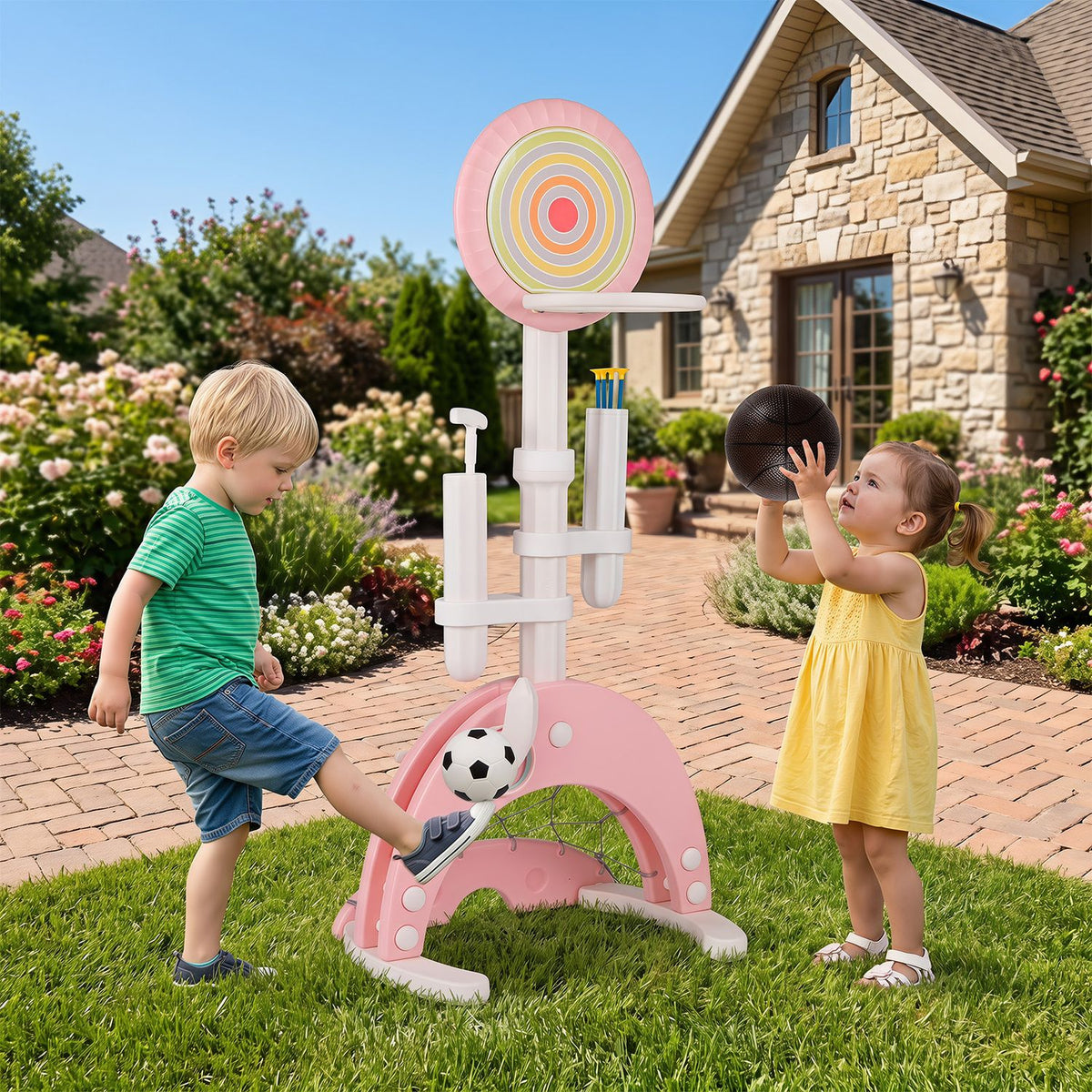 Two children play with a pink basketball hoop and ball on a garden lawn.