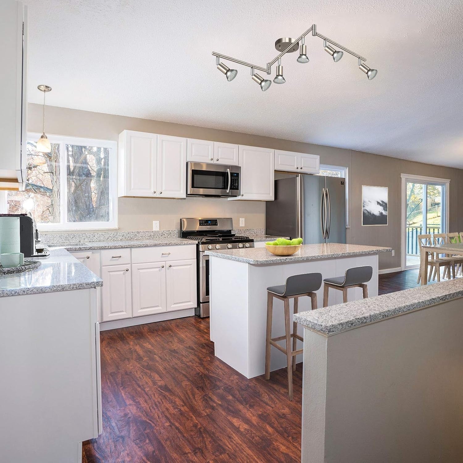 Kitchen with island and a six‑head matte nickel ceiling track light centered above