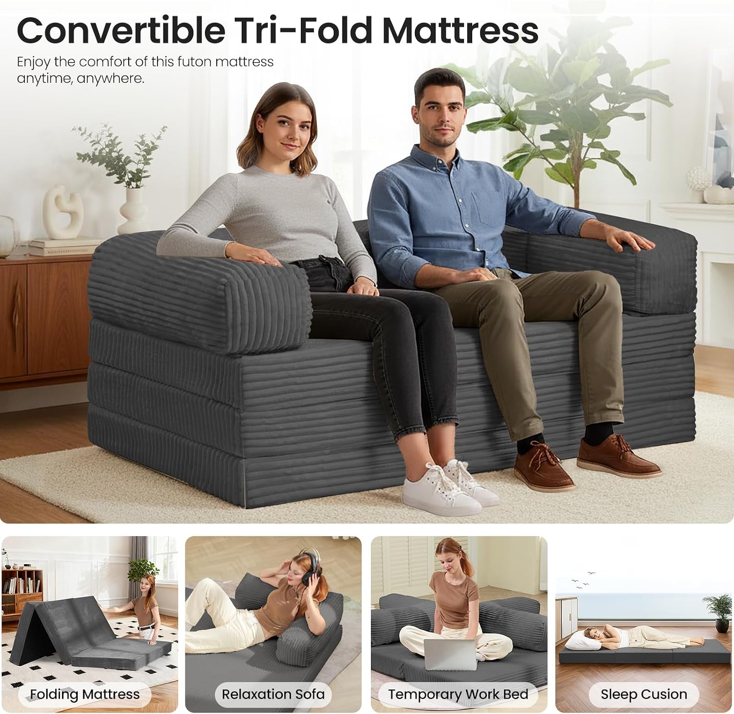 Two people seated on a dark grey tri-fold mattress sofa with removable armrests in a living room.