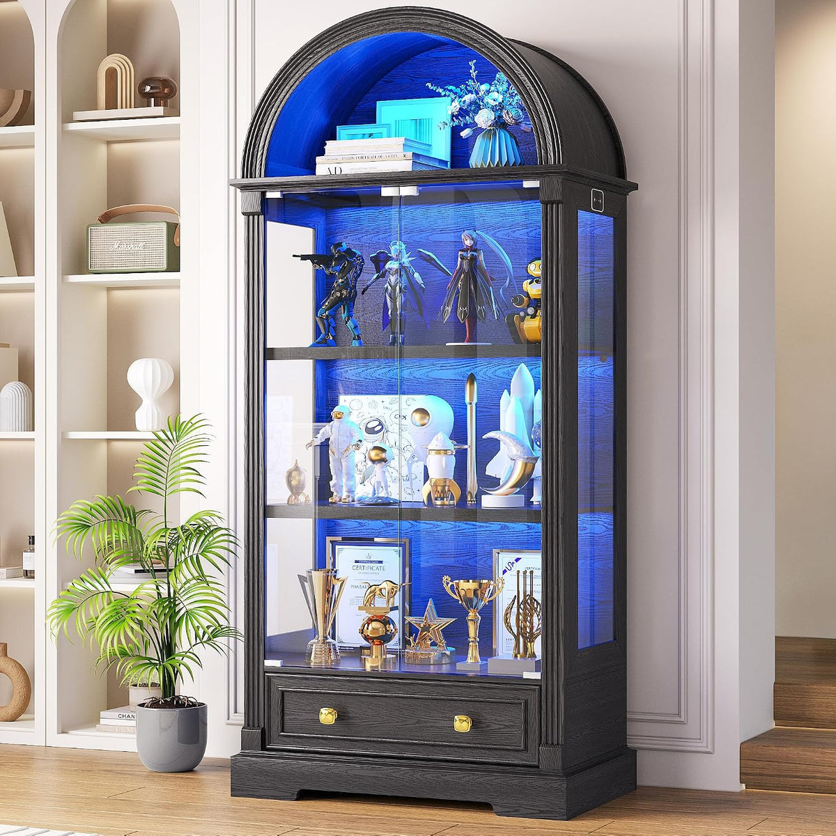 Tall arched black display cabinet with glass doors lit by blue LEDs, holding trophies and collectibles.