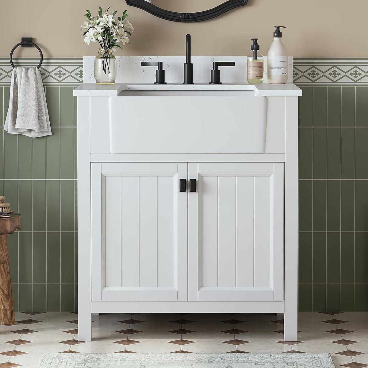 Front view of a white bathroom vanity with apron sink, black faucet and two paneled doors.