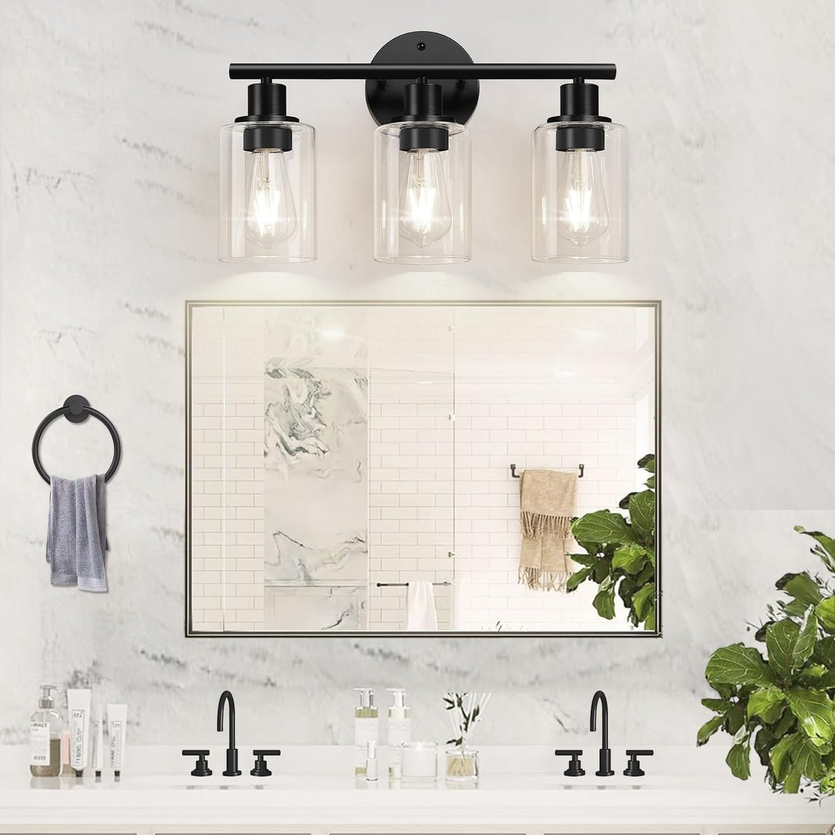 Close frontal view of the black metal three-light vanity with clear glass shades over a double sink