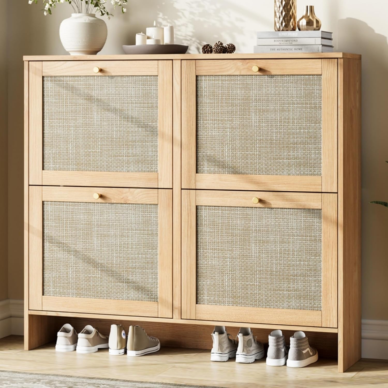 Straight-on cropped view of a light wood, two-column shoe cabinet with woven-texture drawer panels and sunlight on the front.