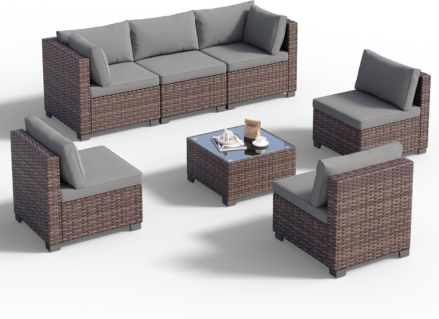 Seven-piece rattan sectional and glass-top coffee table arranged on a white background.