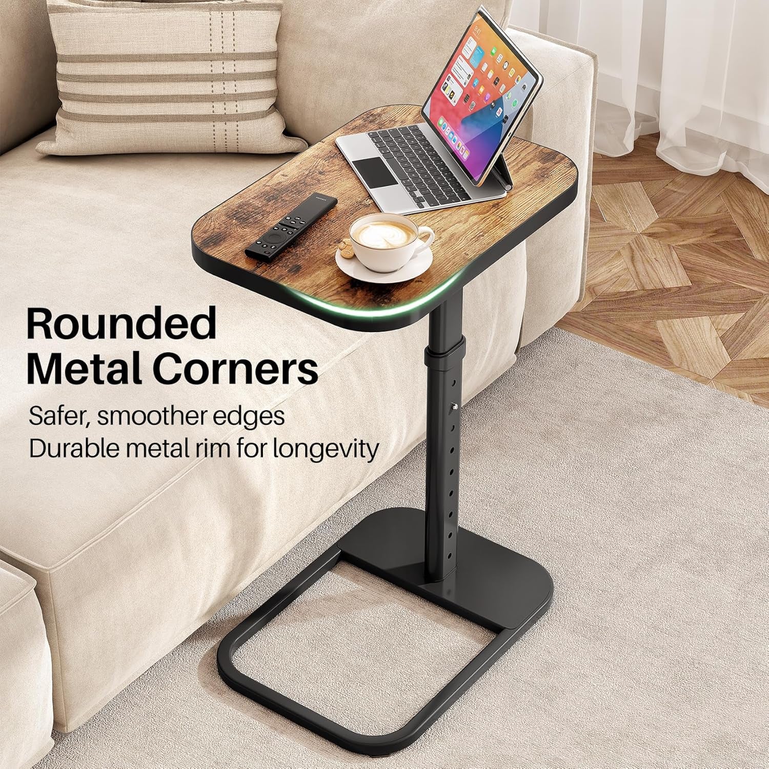 Table beside a couch holding a tablet, remote, and cup, highlighting rounded metal rim and black base.