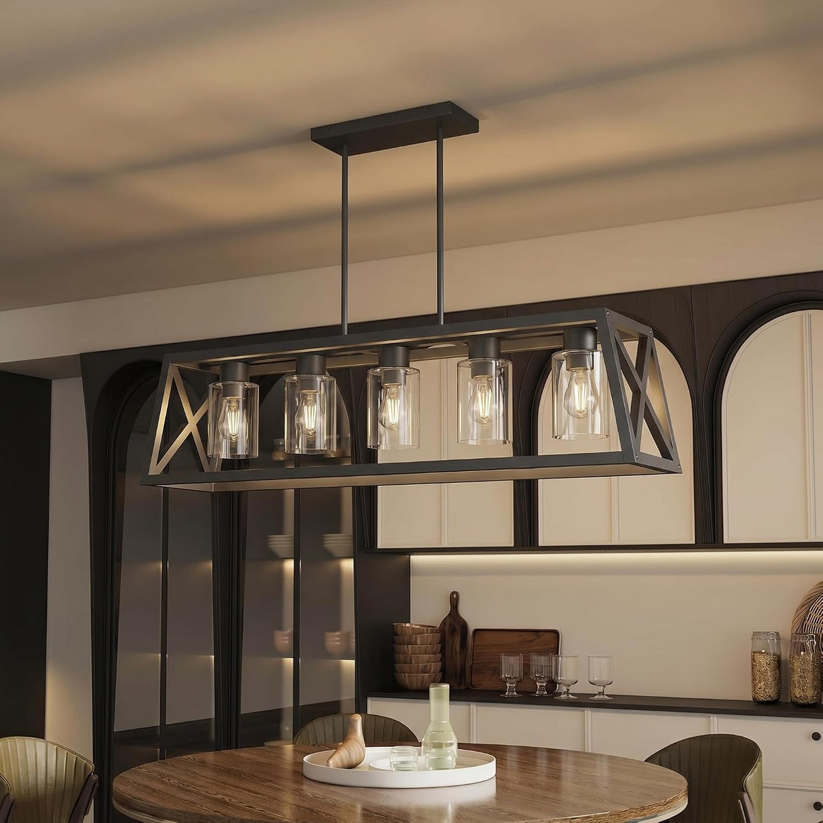 Angled side view of the rectangular chandelier showing exposed filament bulbs inside clear cylindrical glass shades.