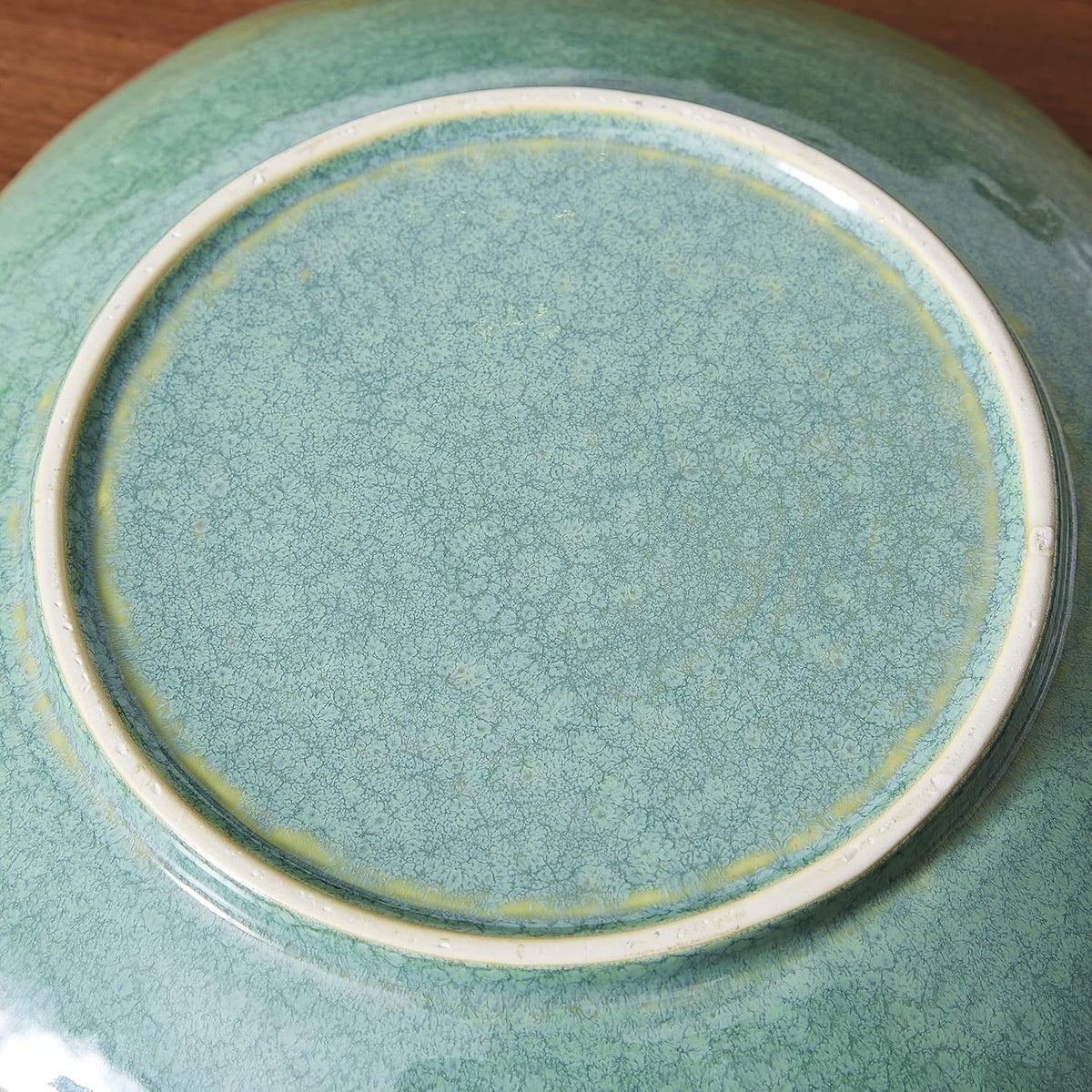 Underside view showing the circular foot and crackled green glaze on the bottom of the bowl
