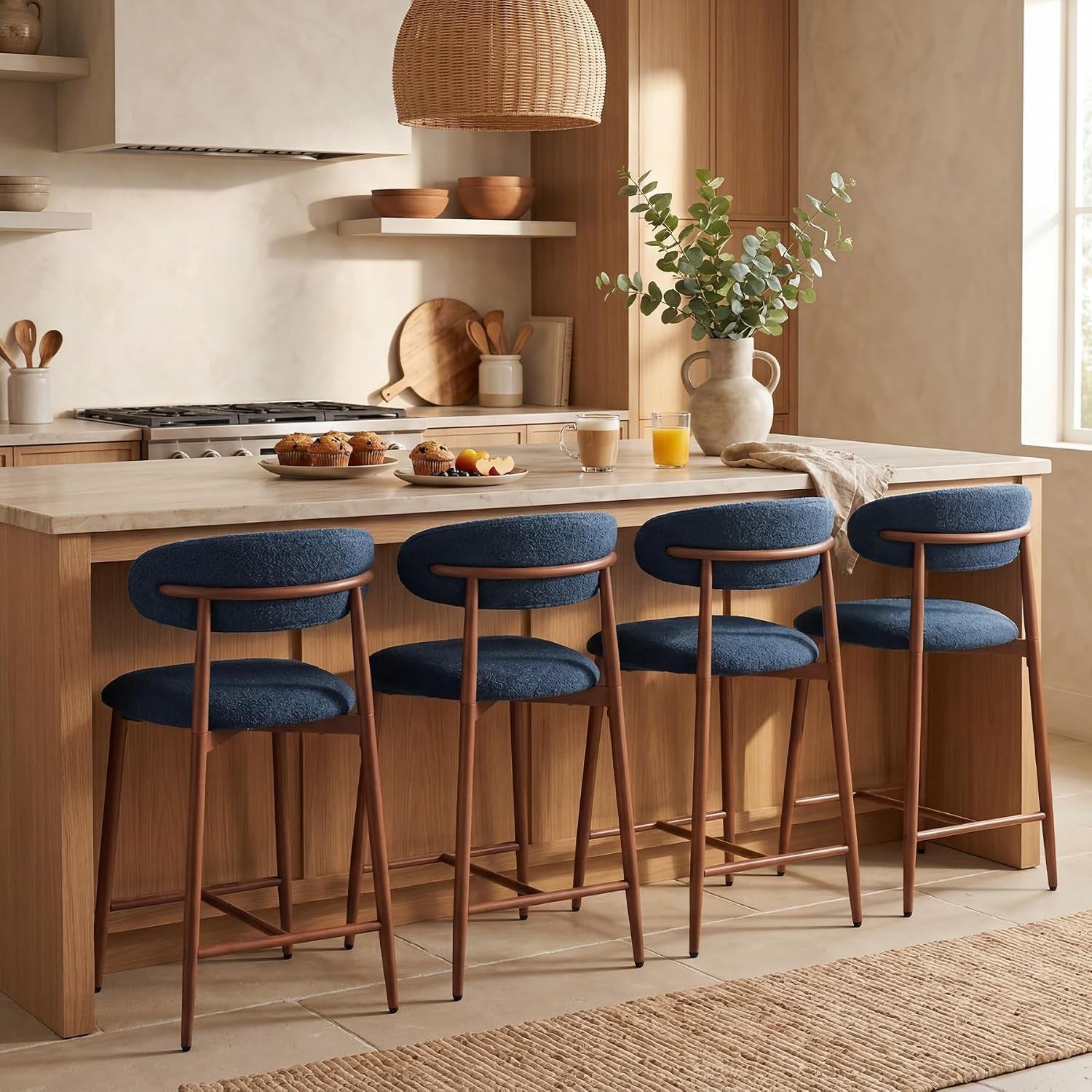 Four navy counter stools shown from the back along a kitchen island with place settings.